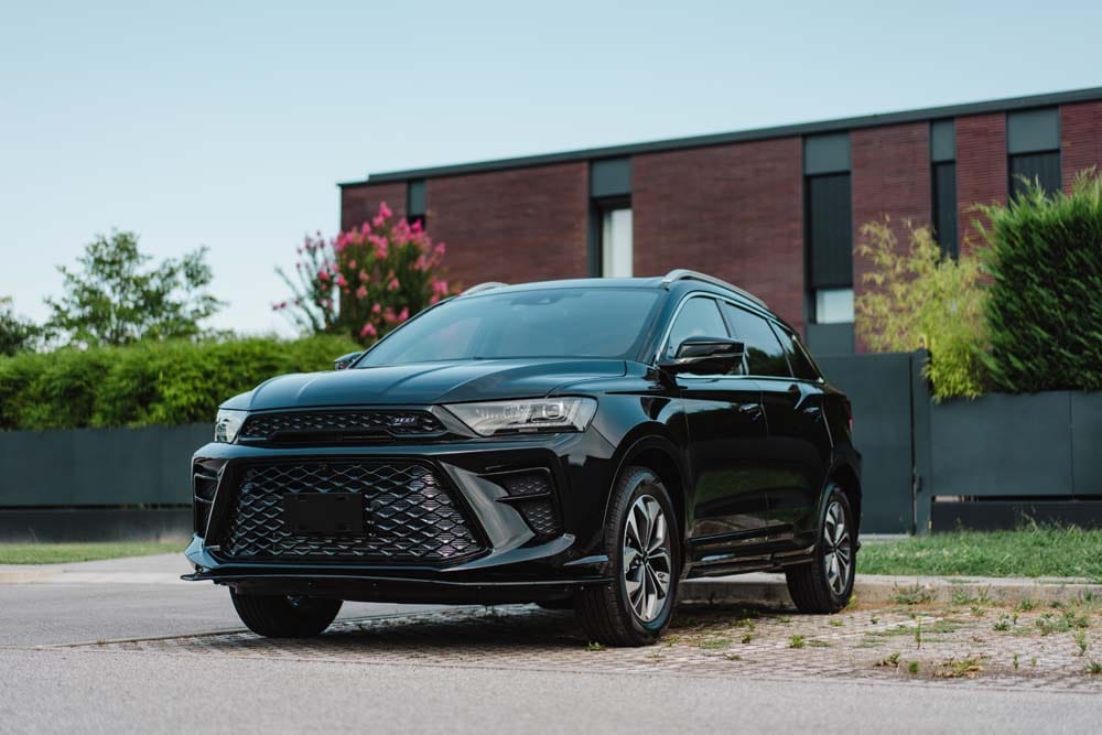 SUV nero parcheggiato davanti a casa moderna